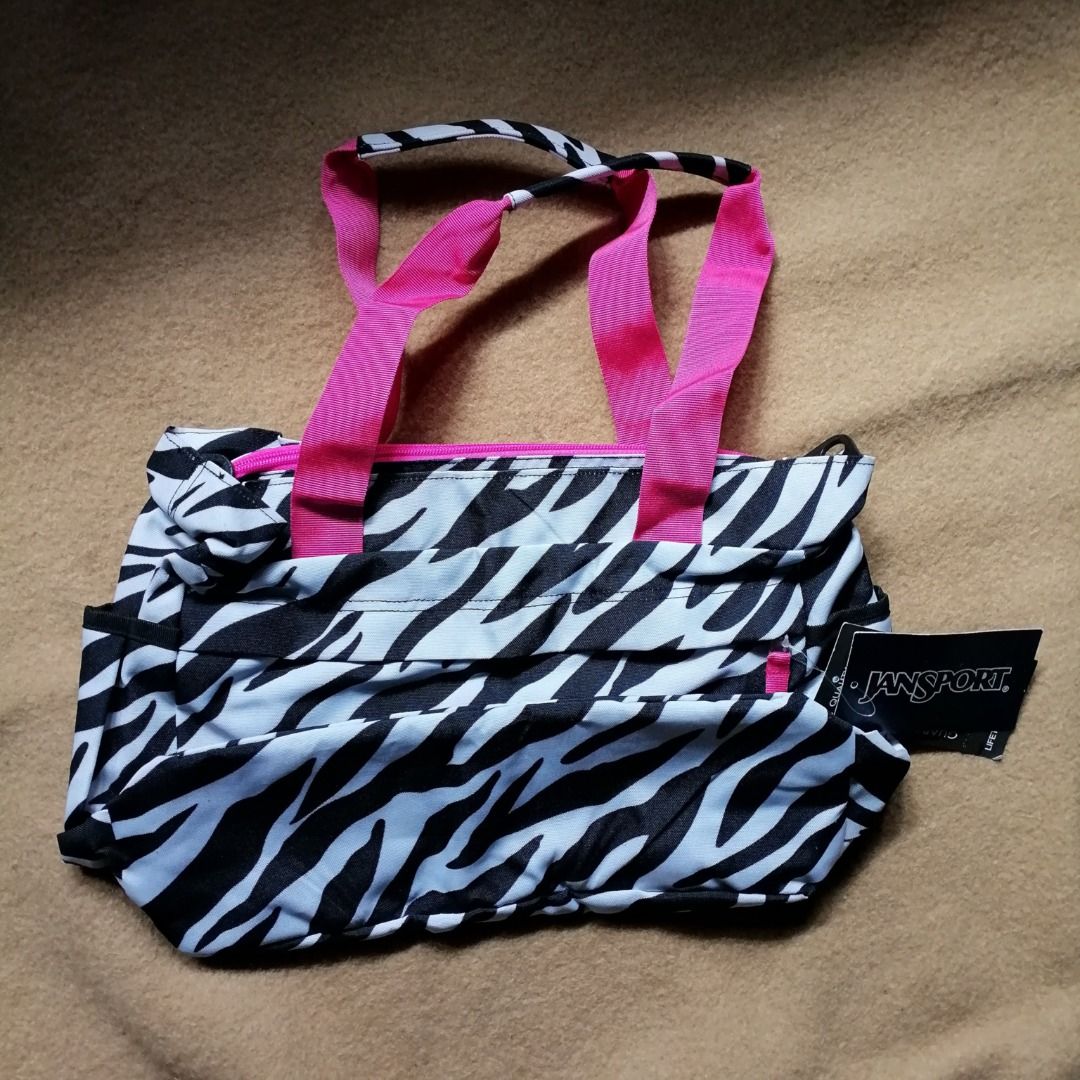 JANSPORT Zebra Print Tote Bag ✨ (Category: Shoulder Bags) located in Itogon. Submitted by m_xary (Listing ID 1466475708, Image 3). Description: 🎀 Features: • Authentic JanSport design • Trendy zebra print pattern • Spacious main compartment for your essentials • Multiple pockets for easy organization • Comfortable pink shoulder straps • Lightweight yet practical • Perfect for everyday, school, or travel use 💗 A stylish + functional everyday bag