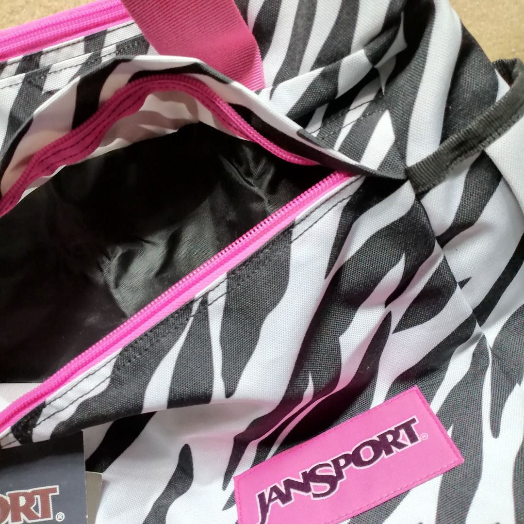 JANSPORT Zebra Print Tote Bag ✨ (Category: Shoulder Bags) located in Itogon. Submitted by m_xary (Listing ID 1466475708, Image 2). Description: 🎀 Features: • Authentic JanSport design • Trendy zebra print pattern • Spacious main compartment for your essentials • Multiple pockets for easy organization • Comfortable pink shoulder straps • Lightweight yet practical • Perfect for everyday, school, or travel use 💗 A stylish + functional everyday bag