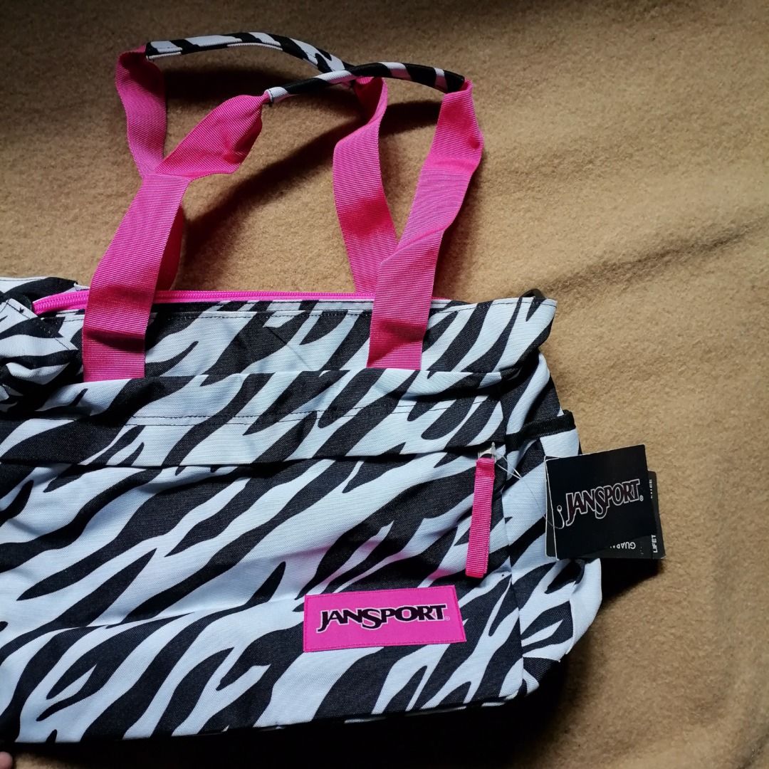 JANSPORT Zebra Print Tote Bag ✨ (Category: Shoulder Bags) located in Itogon. Submitted by m_xary (Listing ID 1466475708, Image 1). Description: 🎀 Features: • Authentic JanSport design • Trendy zebra print pattern • Spacious main compartment for your essentials • Multiple pockets for easy organization • Comfortable pink shoulder straps • Lightweight yet practical • Perfect for everyday, school, or travel use 💗 A stylish + functional everyday bag