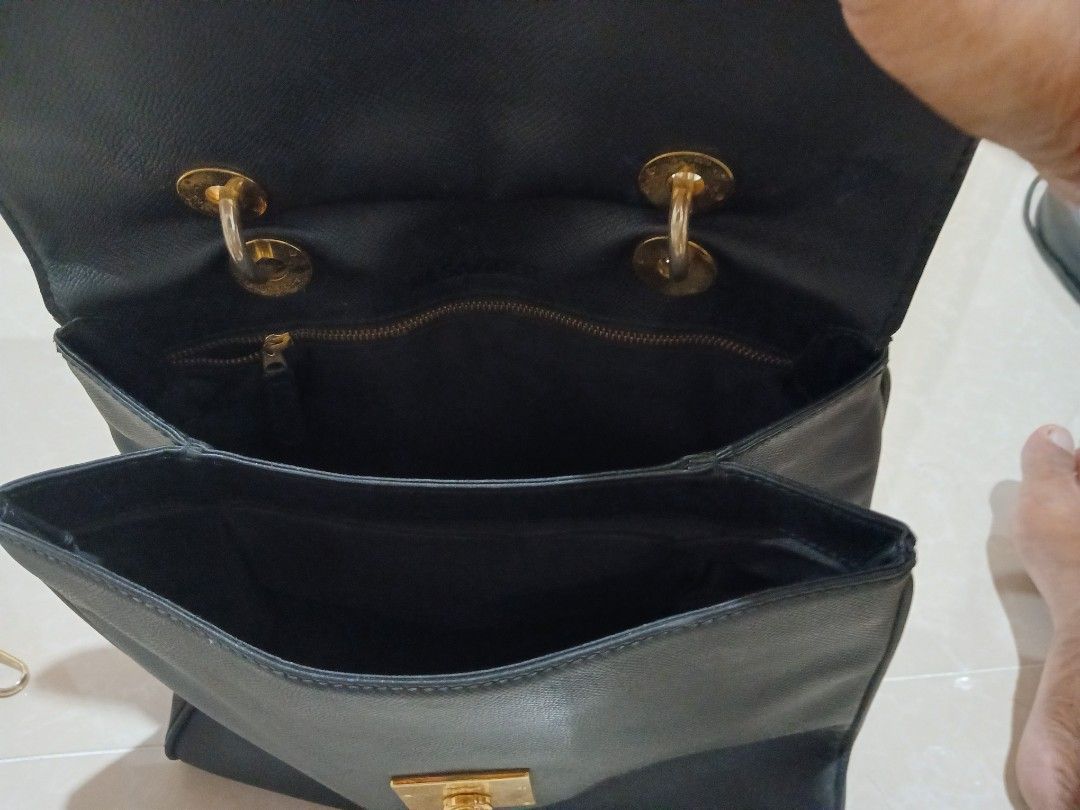 Jil Sander Black Leather Handbag (Category: Luxury Bags & Wallets) located in Quezon City. Submitted by mcenon35 (Listing ID 1466494880, Image 1). Description: - Brand: Jil Sander - Material: Premium black leather with luxury gold hardware - Closure: Front flap with secure lock detail - Versatile carry: Includes top handles and a detachable shoulder strap - Interior: Clean black lining with a zip pocket and multiple compartments for organization 