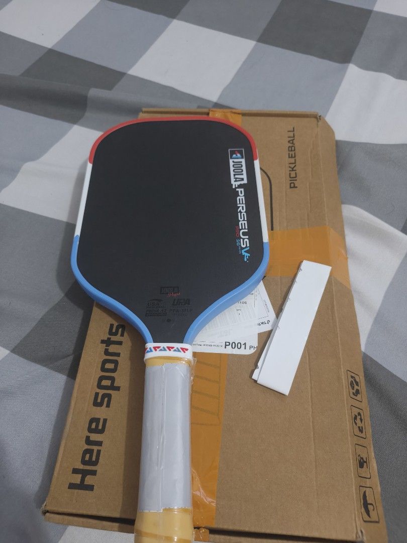 Joola Perseus Pro 16mm Pickleball Paddle (Category: Racket and Ball Sports) located in Manila. Submitted by torresj.0602 (Listing ID 1466550698, Image 1). Description: - Brand: OEM Joola Perseus Pro 16mm Pickleball Paddle - Condition: Brand new and unused - Design: Sleek black surface with striking blue and red edge guard - Handle: Still wrapped in protective plastic with the official warranty sticker intact - Inclusion: Original box included - P