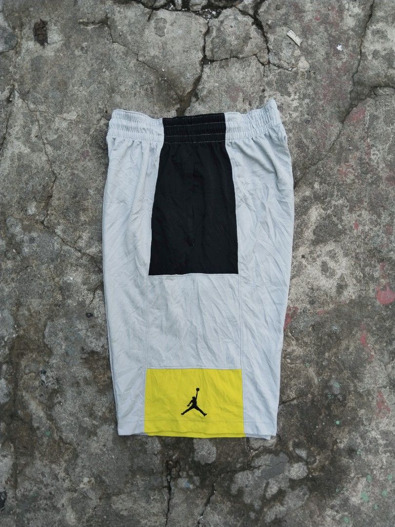 Jordan Bankroll Version 3 (Category: Shorts) located in Tabaco. Submitted by skycat_29 (Listing ID 1466383887, Image 2). Description: - Brand: Jordan - Size: Medium (Style code: 729413-012, SU15) - Color: Grey, black, and yellow colorblock - Material: Breathable mesh polyester, machine washable - Features: Elastic waistband with adjustable drawstring - Details: Iconic Jumpman logo on the yellow hem and small side tag.
