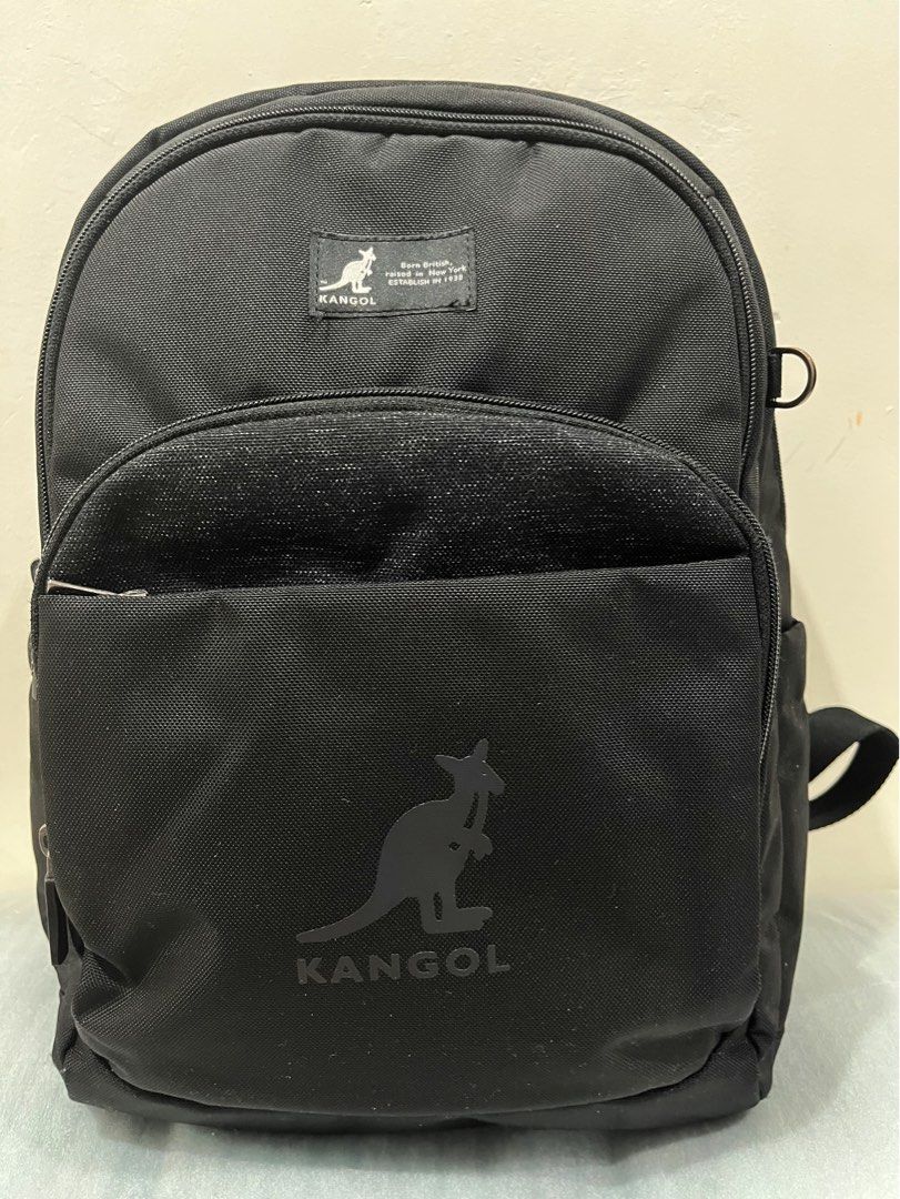 Kangol Black Backpack Bag (Category: Backpacks) located in Talisay. Submitted by cherylu (Listing ID 1466561817, Image 1). Description: - Brand: Kangol - Color: Classic Black with large front kangaroo logo - Comfort: Padded mesh back panel for all-day wear - Storage: Spacious main compartment for school or work essentials - Interior Features: Built-in name/school tag slot and a secure zippered pocket with brand tag - Quality: Durable exterior fab