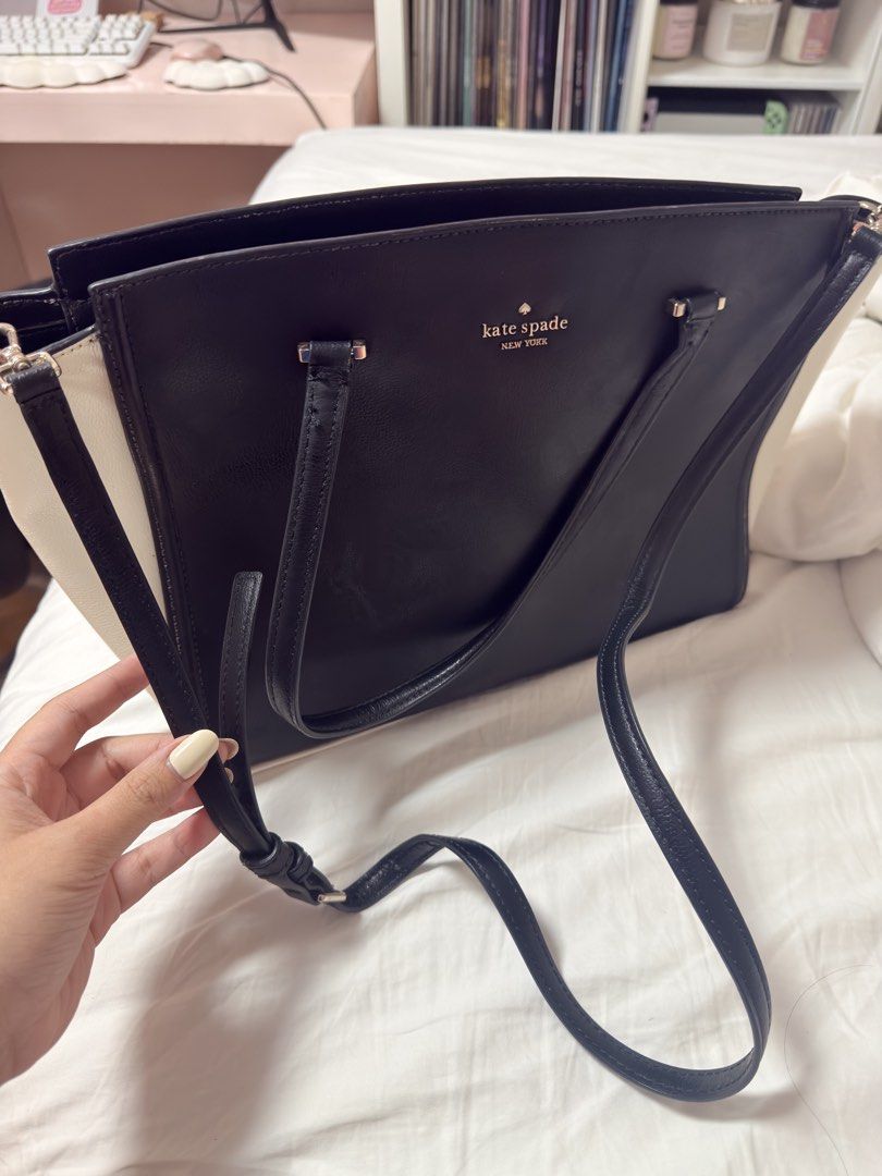 Kate Spade Black and White Tote Bag (Category: Tote Bags) located in Manila. Submitted by annmaryelp (Listing ID 1466450495, Image 2). Description: - Brand: Kate Spade - Color: Classic black leather with contrast white side panels - Hardware: Premium gold-toned logo lettering and accents - Carry Options: Double top handles and a removable, adjustable shoulder strap - Closure: Secure top-zip closure - Interior: Signature spade jacquard lining with