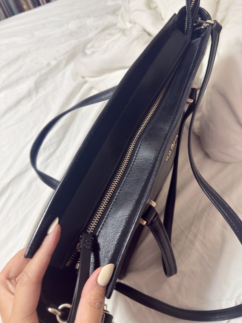 Kate Spade Black and White Tote Bag (Category: Tote Bags) located in Manila. Submitted by annmaryelp (Listing ID 1466450495, Image 3). Description: - Brand: Kate Spade - Color: Classic black leather with contrast white side panels - Hardware: Premium gold-toned logo lettering and accents - Carry Options: Double top handles and a removable, adjustable shoulder strap - Closure: Secure top-zip closure - Interior: Signature spade jacquard lining with