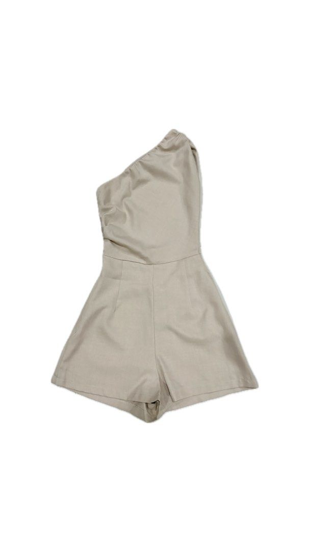 Khaki One-Shoulder Asymmetric Romper (Category: Rompers) located in Paranaque City. Submitted by honeykkkk (Listing ID 1466525190, Image 1). Description: • Details: Chic modern asymmetric one-shoulder neckline with subtle side ruching detail, tailored high waist, and comfortable loose-fit shorts layout. A versatile neutral piece perfect for casual night outs, parties, or weekend dates. • Condition: Excellent condition — worn once only. • Original