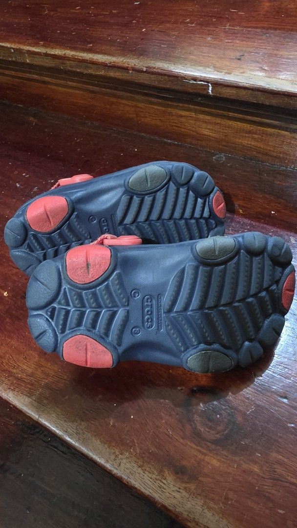 Kids Dark Navy Crocs Clogs with Jibbitz Charms (Category: Babies & Kids Fashion) located in Valenzuela. Submitted by bella_onez (Listing ID 1466445709, Image 2). Description: - Color: Dark navy toddler Crocs - Features: Adjustable straps for a secure fit - Includes: Fun Jibbitz charms (dogs, ducks, Cheetos packet, baseball gear, and evil eye) - Condition: Minor wear on bottom soles from normal use - Ideal for: Easy, everyday slip-on wear for kids