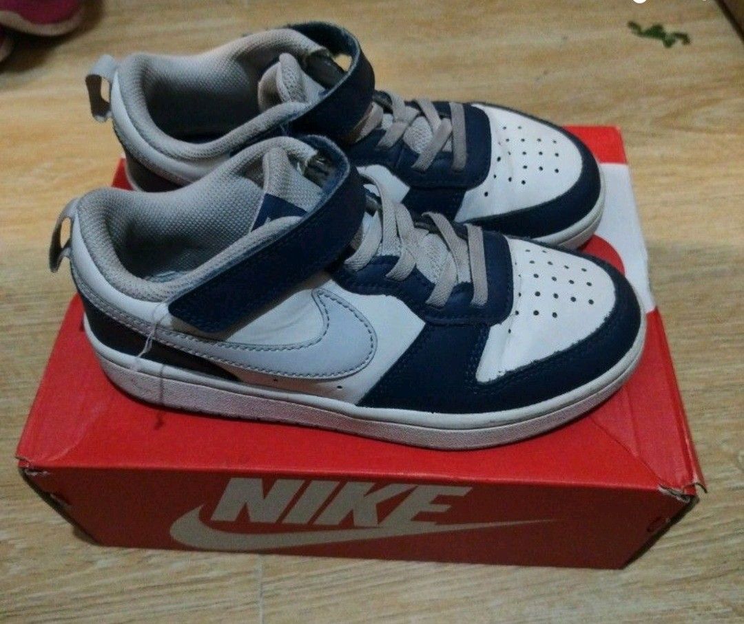 Kids Nike Shoes 10c (Category: Babies & Kids Fashion) located in Marilao. Submitted by majoriety (Listing ID 1466351595, Image 1). Description: - Brand: Nike - Colorway: Blue and white - Style: Classic low-top with lace-up closure and ankle strap - Features: Perforated toe box for breathability - Condition: Clean soles and great structure overall - Inclusions: Comes with original red Nike shoebox - Ideal for: Kids' everyday wear.