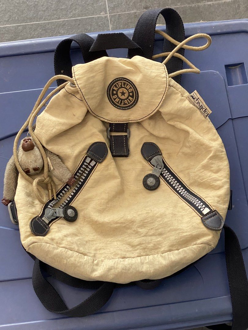 Kipling Backpack with Monkey Charm (Category: Backpacks) located in Manila. Submitted by mpt99876 (Listing ID 1466521214, Image 2). Description: - Cute Kipling backpack - Light beige color - Signature monkey charm included - Drawstring closure with buckle flap - Two front zip pockets - Adjustable straps - Ideal for everyday use.