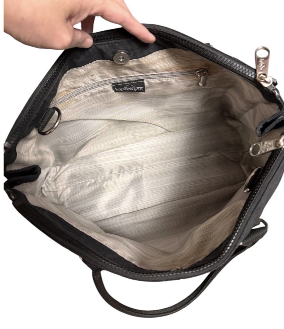 Kipling Two Way Multi Compartment Shoulder Bag (Category: Beach Bags) located in Baguio. Submitted by pwz-eshop (Listing ID 1466392684, Image 3). Description: • Up for Grabs!! • Guaranteed Authentic!! • Flaws: Stains on lining. (please see photos) • BRAND: KIPLING. • DIMENSIONS: length 16", height 11", width 6.5", handle drop: 7.5". • SERIAL NUMBER: With code. • COUNTRY OF ORIGIN: CHINA. • MATERIAL: Polyester. • COLOR: Black. • Lining: Canvas. • 