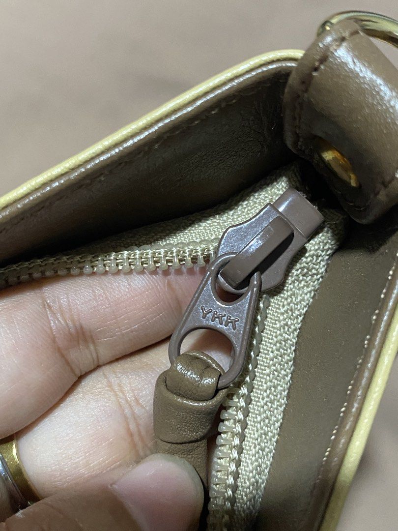 Kitamura Light Yellow Leather Crossbody Bag (Category: Cross-body Bags) located in Manila. Submitted by cdb_22 (Listing ID 1466438640, Image 3). Description: - Brand: Kitamura - Style: Crossbody bag - Color: Light yellow with brown straps and trim - Material: Genuine leather with smooth monogram-patterned lining - Hardware: Smooth YKK zippers - Branding: Debossed 'K' logo on the front lower corner - Compartments: Main zip compartment, interior zi