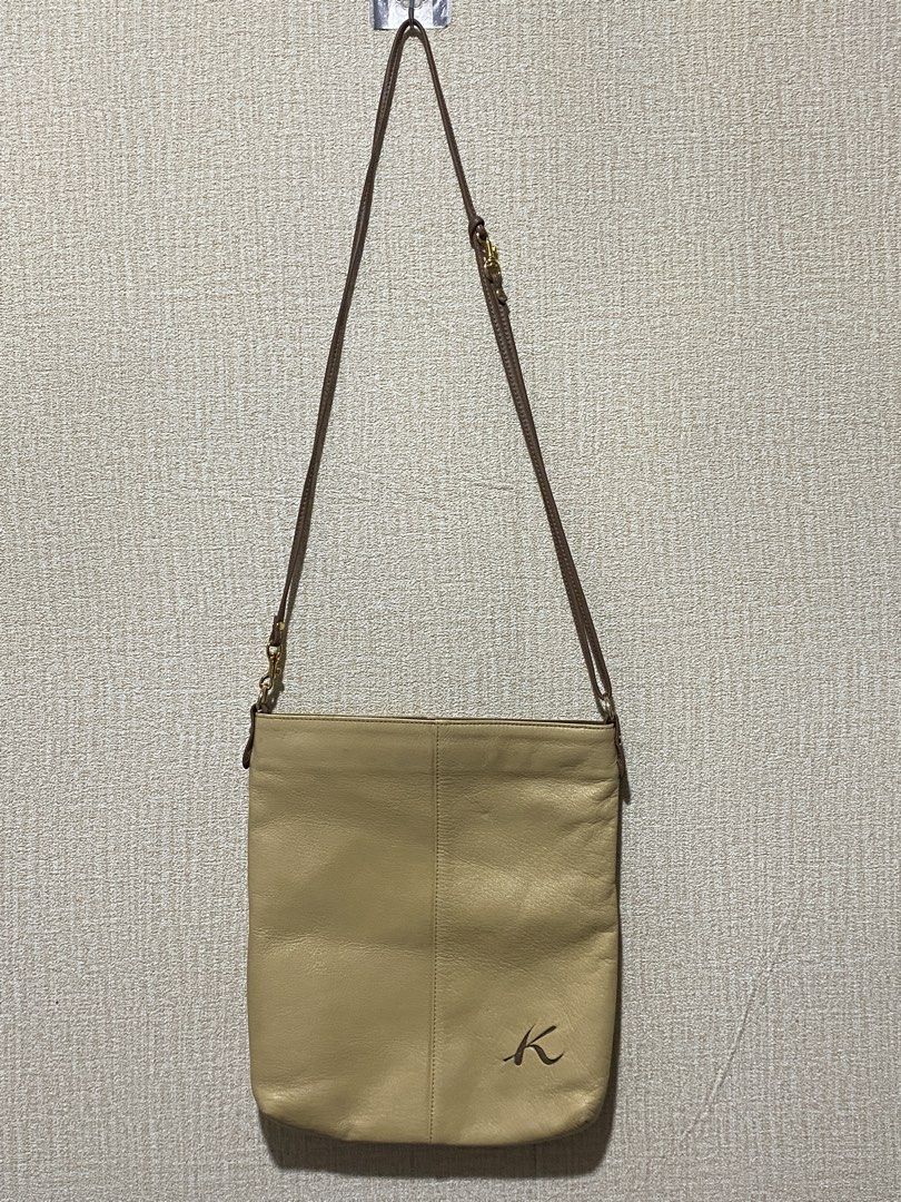 Kitamura Light Yellow Leather Crossbody Bag (Category: Cross-body Bags) located in Manila. Submitted by cdb_22 (Listing ID 1466438640, Image 1). Description: - Brand: Kitamura - Style: Crossbody bag - Color: Light yellow with brown straps and trim - Material: Genuine leather with smooth monogram-patterned lining - Hardware: Smooth YKK zippers - Branding: Debossed 'K' logo on the front lower corner - Compartments: Main zip compartment, interior zi