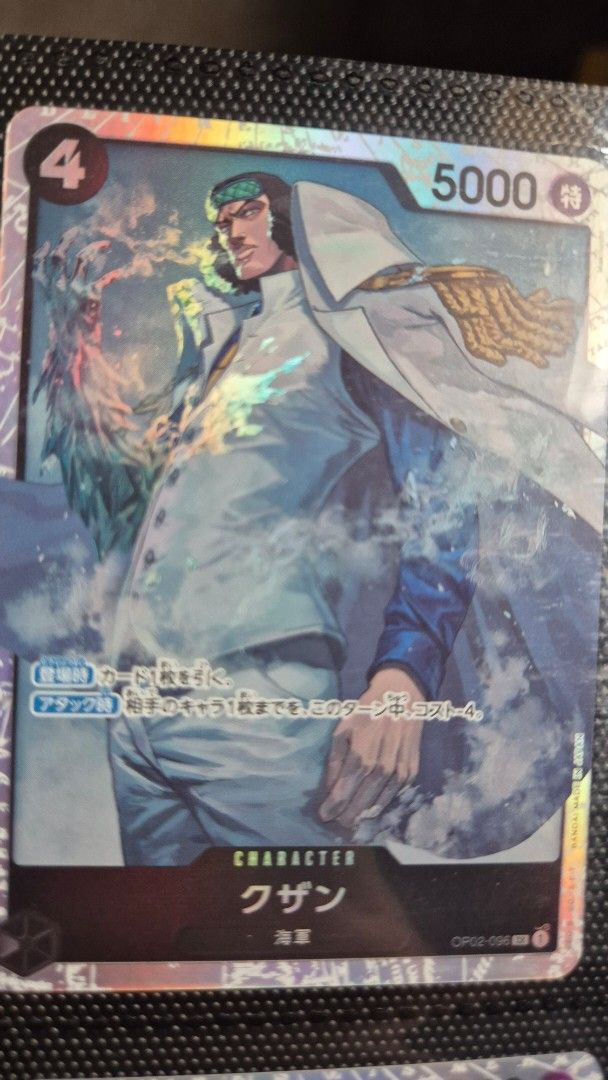Kuzan OP02-096 (Category: Raw Singles) located in Muntinlupa City. Submitted by lazoftoys (Listing ID 1466351368, Image 1). Description: - Card: Kuzan (OP02-096) - Set: Paramount War (Japanese) - Faction: Marine - Stats: Cost 4 | Power 5000 - Finish: Foil Holo - Condition: Near Mint / Pack-fresh (stored in binder since pull).
