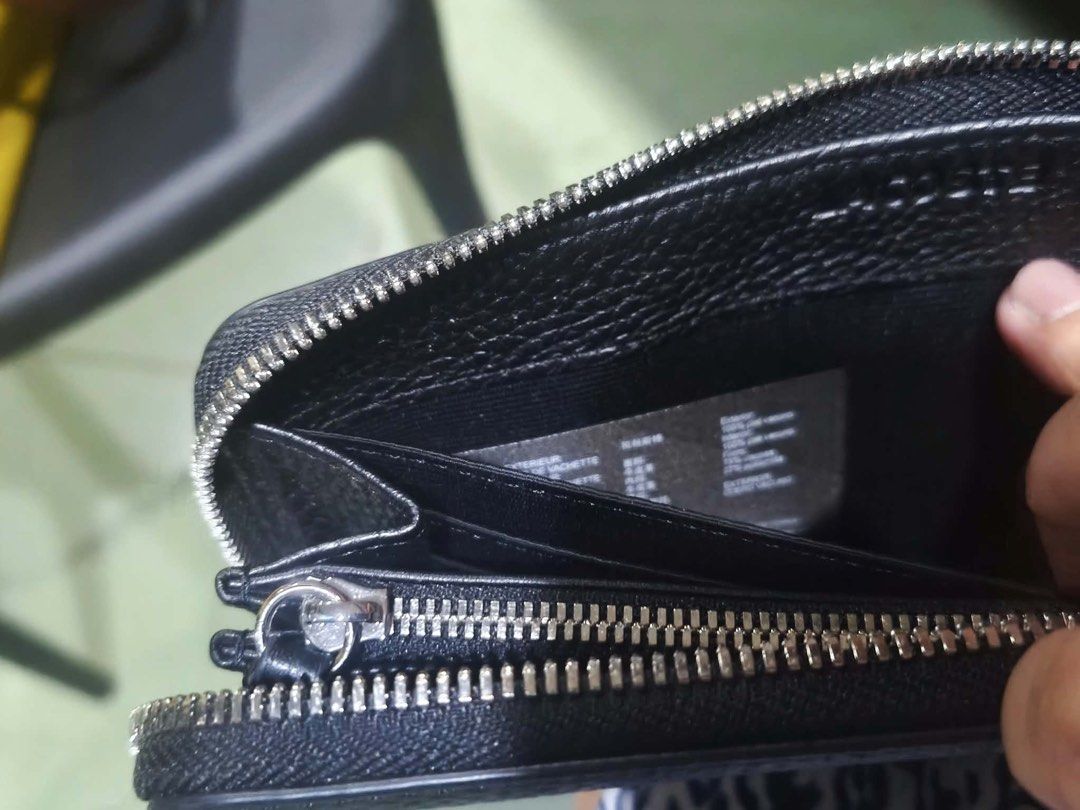 Lacoste Black Zip Around Wallet (Category: Wallets & Card holders) located in Quezon City. Submitted by prelovedbykg_ (Listing ID 1466375879, Image 1). Description: - Brand: Lacoste - Material: Premium black pebble leather - Hardware: Silver-tone with secure zip-around closure - Interior: Multiple card slots, spacious compartments, and a zippered coin pocket - Condition: Brand new - 100% authentic and ready to ship!.
