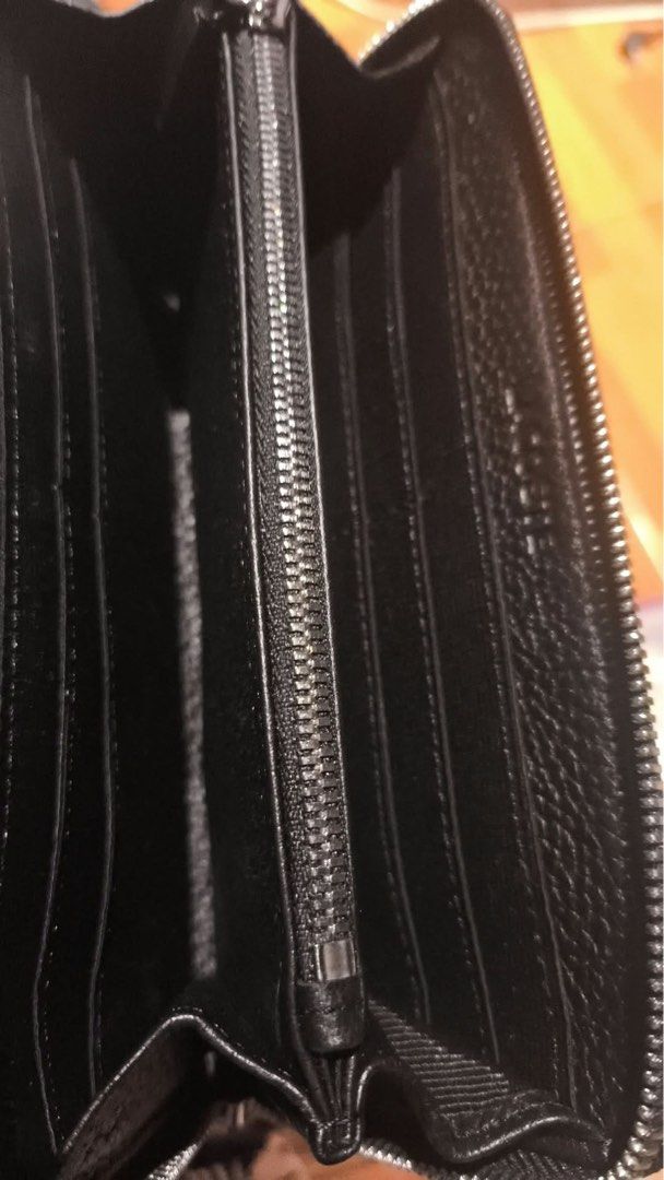Lacoste Black Zip Around Wallet (Category: Wallets & Card holders) located in Quezon City. Submitted by prelovedbykg_ (Listing ID 1466375879, Image 3). Description: - Brand: Lacoste - Material: Premium black pebble leather - Hardware: Silver-tone with secure zip-around closure - Interior: Multiple card slots, spacious compartments, and a zippered coin pocket - Condition: Brand new - 100% authentic and ready to ship!.