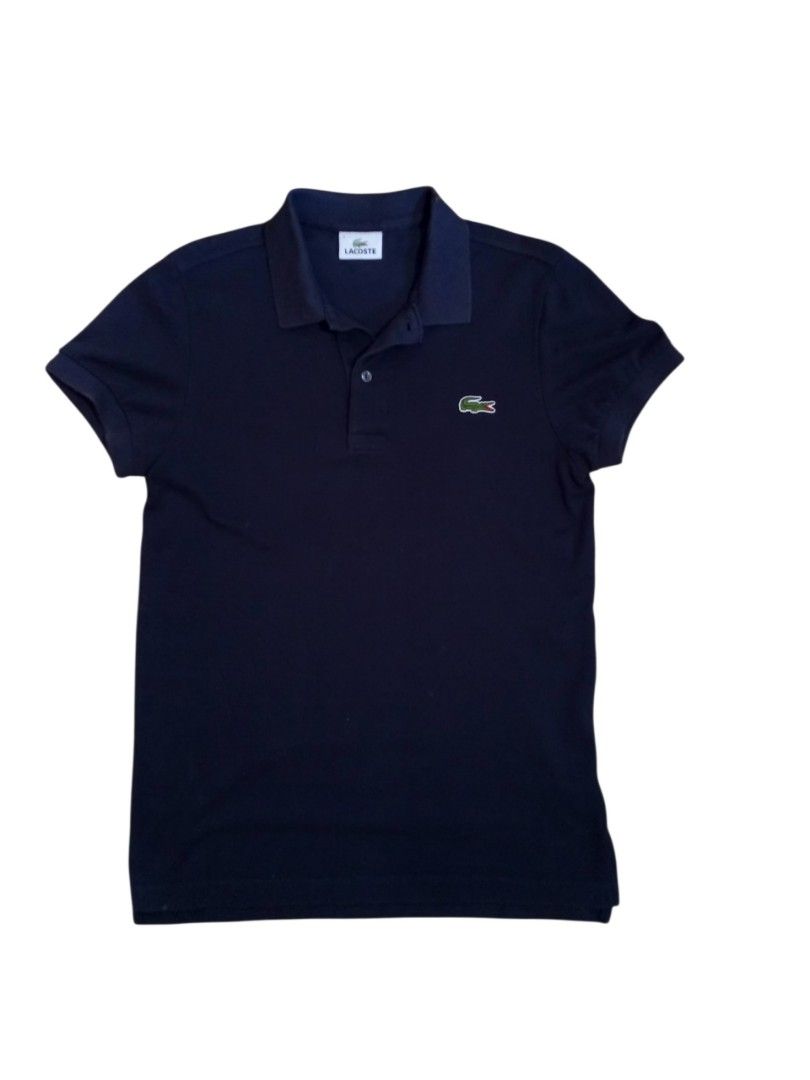 Lacoste Navy Blue Polo Shirt (Category: Tshirts & Polo Shirts ) located in Manila. Submitted by jeancharis67207 (Listing ID 1466523735, Image 1). Description: - Brand: Lacoste - Color: Classic dark navy blue - Material: Clean, breathable cotton fabric - Design: Short sleeves, standard collar, two-button placket - Branding: Iconic embroidered green crocodile logo on the left chest with white Lacoste brand label inside - Style: Versatile staple pie