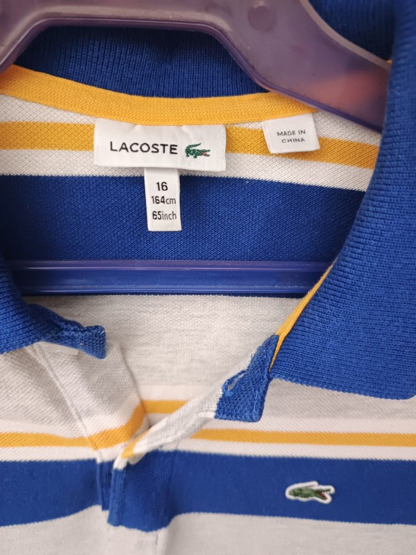 Lacoste polo shirt (Category: Activewear) located in Odiongan. Submitted by thriftngo26 (Listing ID 1466356635, Image 2). Description: This is a blue, gray, and yellow striped short-sleeve polo shirt by Lacoste featuring the brand's signature embroidered green crocodile logo on the chest.