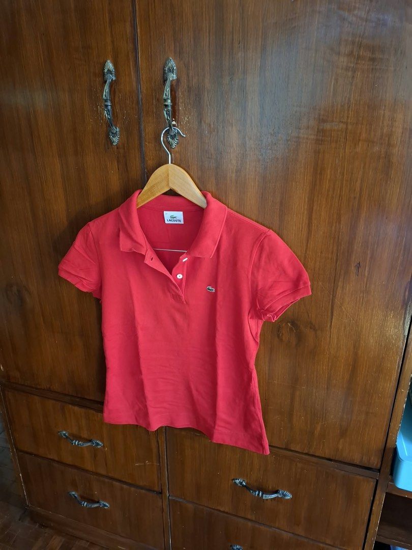 Lacoste Red Polo Shirt Size 40 (Category: Tshirts & Polo Shirts ) located in Manila. Submitted by bunbun__ (Listing ID 1466413910, Image 2). Description: - Brand: Lacoste - Color: Bright red - Size: 40 (Classic Fit) - Material: Cotton piqué fabric - Details: Classic button placket with white buttons, ribbed collar and cuffs - Logo: Small embroidered crocodile on the chest - Condition: Clean, vibrant color, and ready to wear.