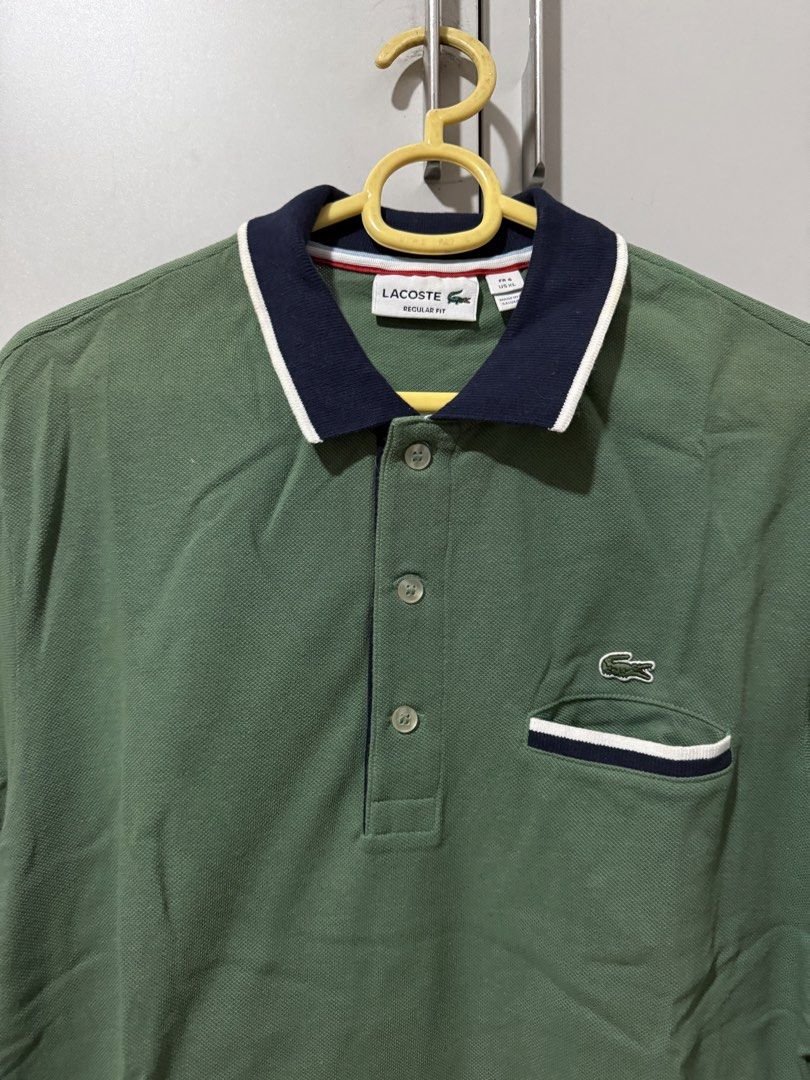Lacoste Regular Fit Polo Shirt Green (Category: Tshirts & Polo Shirts ) located in Manila. Submitted by mpt99876 (Listing ID 1466520982, Image 1). Description: - Authentic Green Lacoste Polo Shirt - Size: XL - Fit: Regular - Features: Classic crocodile logo on chest - Design: Contrasting navy collar and pocket trim with white stripes - Sleeves: Short with navy trim - Closure: Button-up placket.