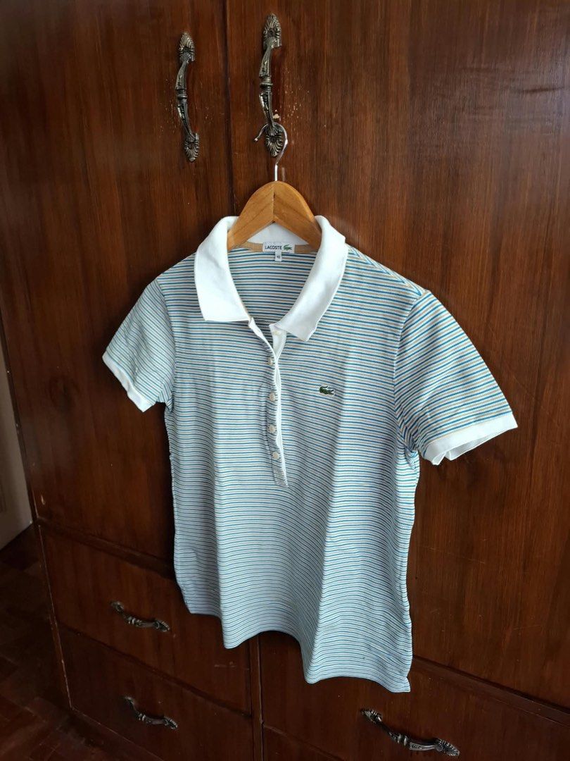 Lacoste Striped Polo Shirt Size 42 (Category: Tshirts & Polo Shirts ) located in Manila. Submitted by bunbun__ (Listing ID 1466415032, Image 2). Description: - Brand: Lacoste - Design: White, blue, and tan stripes with solid white collar and sleeve cuffs - Details: Four-button placket and iconic green crocodile logo on the chest - Size: 42 (Regular fit).