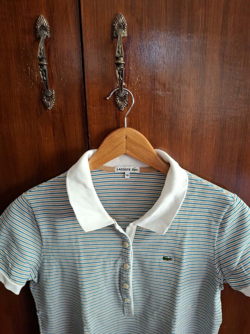 Lacoste Striped Polo Shirt Size 42 (Category: Tshirts & Polo Shirts ) located in Manila. Submitted by bunbun__ (Listing ID 1466415032, Image 1). Description: - Brand: Lacoste - Design: White, blue, and tan stripes with solid white collar and sleeve cuffs - Details: Four-button placket and iconic green crocodile logo on the chest - Size: 42 (Regular fit).