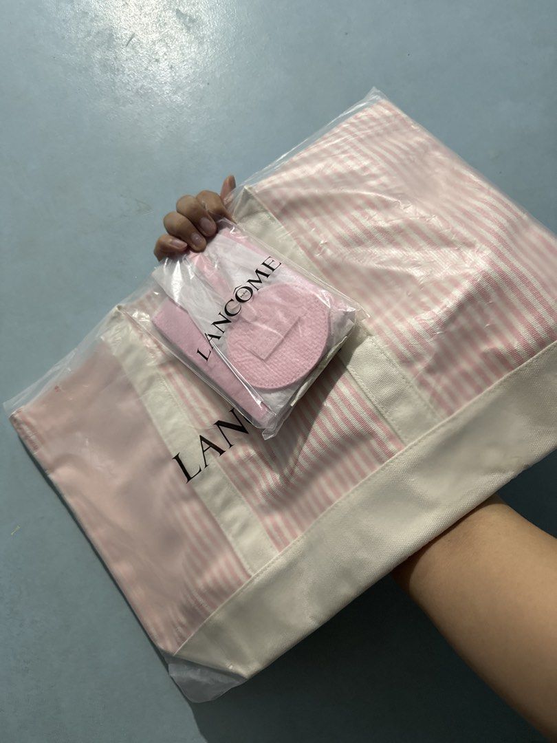 Lancôme Travel Set (Category: Tote Bags) located in Bulacan. Submitted by journeyingsisi (Listing ID 1466455718, Image 1). Description: - Brand: Lancôme - Item: Travel Tote Bag with Bag Charm and Passport Holder - Color/Pattern: Pink and white stripes - Material: Heavy canvas with sturdy white handles and bottom gussett - Condition: Brand new, unopened, with original tags and barcodes attached - Free Shipping.