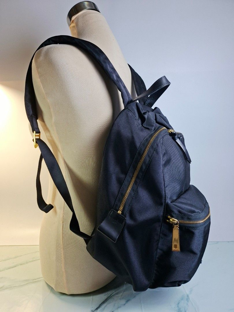 Lanvin en Bleu Black Nylon Backpack with Bow Detail (Category: Luxury Bags & Wallets) located in Pasay City. Submitted by onick_79 (Listing ID 1466493671, Image 3). Description: - Brand: Lanvin en Bleu - Material: Durable black nylon with gold hardware - Design: Features a cute ribbon detail near the top handle - Storage: Dual front zippered compartments and convenient side zipper access - Comfort: Adjustable shoulder straps with padded support -
