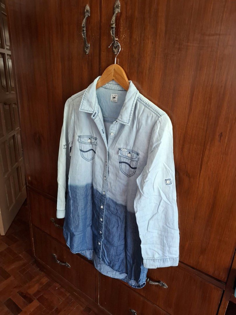 Lee Denim Button-Down Shirt Ombre Light Blue (Category: Tshirts & Polo Shirts ) located in Manila. Submitted by bunbun__ (Listing ID 1466450641, Image 2). Description: - Brand: Lee - Size: XL - Design: Light-to-dark blue ombre wash fade - Sleeves: Long sleeves with convenient roll-up tabs - Pockets: Dual chest pockets with button flaps and Lee logo embroidery - Closure: Classic collar with front metal buttons - Condition: Excellent pre-loved/read