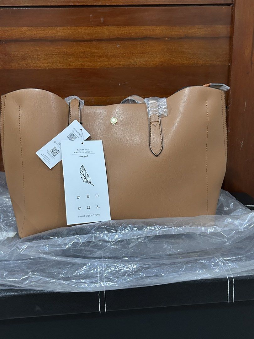 Legato Largo Light Weight Tote Bag Brown (Category: Tote Bags) located in Pasig City. Submitted by krishnasingh2020 (Listing ID 1466401804, Image 3). Description: - Brand: Legato Largo - Color: Nice brown shade - Condition: Brand new with tags attached, handles still in original plastic - Features: Super lightweight, spacious interior, secure zipped middle compartment, and magnetic closure - Ideal for: Daily use, work, or school.