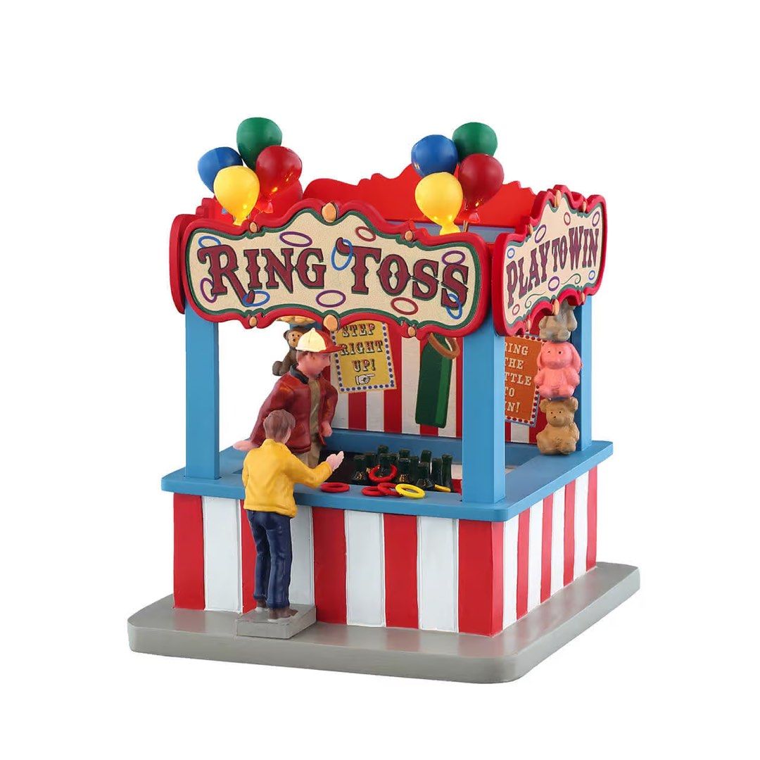 Lemax Carnival Ring Toss Lighted Building Figurine #54459 (Category: Figurines & Statues) located in Santiago. Submitted by kitalpanga (Listing ID 1466389666, Image 1). Description: - Brand: Lemax Carnival Collection - Item: Ring Toss Booth Figurine (#54459) - Design: Classic red & white striped tent with colorful balloons, prizes, and playing figures - Power: Operates on 3 AA batteries / AC adaptable - Condition: Includes original retail boxes -