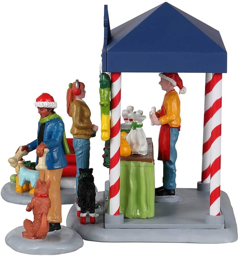 Lemax Santa Claws & Paws Shop (Category: Figurines & Statues) located in Santiago. Submitted by kitalpanga (Listing ID 1466389087, Image 3). Description: - Festive Santa Claws and Paws Christmas village miniature set - Includes vibrant market tent and shopper/worker figures - Adorable dogs dressed in cozy winter outfits - Comes with a mini sleigh loaded with gifts and toy bones - Eye-catching red, blue, green, and white holiday colors - Perfect a