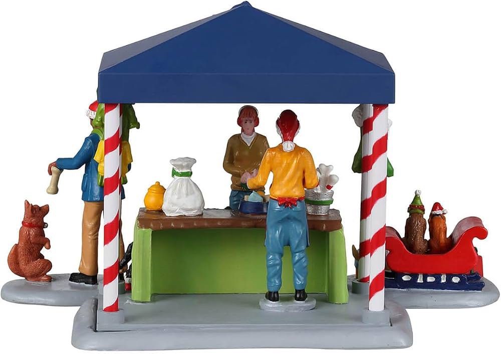 Lemax Santa Claws & Paws Shop (Category: Figurines & Statues) located in Santiago. Submitted by kitalpanga (Listing ID 1466389087, Image 2). Description: - Festive Santa Claws and Paws Christmas village miniature set - Includes vibrant market tent and shopper/worker figures - Adorable dogs dressed in cozy winter outfits - Comes with a mini sleigh loaded with gifts and toy bones - Eye-catching red, blue, green, and white holiday colors - Perfect a