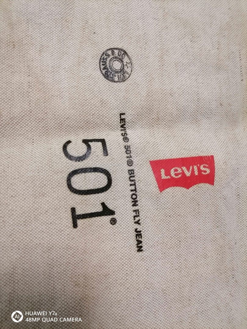 Levi's 501 Canvas Tote Bag (Category: Tote Bags) located in Naga. Submitted by mrwisethrifter (Listing ID 1466365635, Image 2). Description: - Authentic Levi's off-white canvas tote bag - Features iconic 501 button fly graphic and signature red tab - Durable heavy cotton material with contrast red stitching - Single shoulder strap design for easy carrying - Spacious and versatile for books, groceries, or daily essentials - Condition: Brand new / 