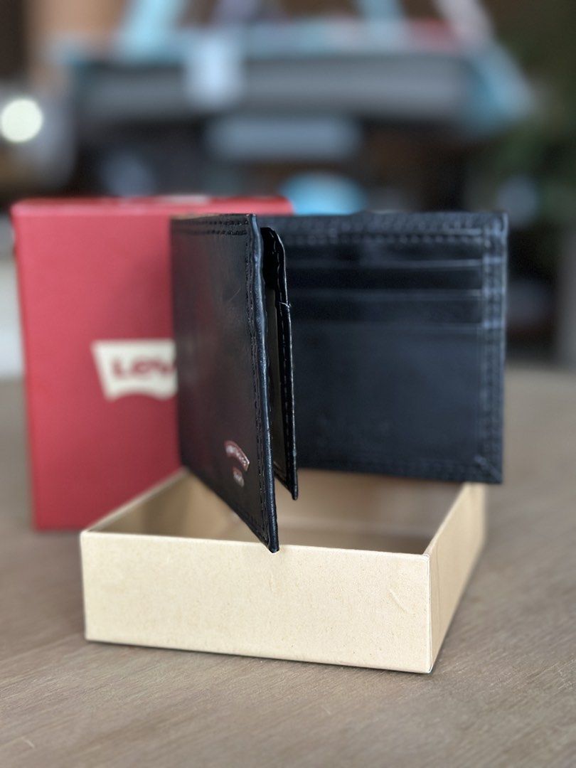 Levi's black leather RFID blocking bifold wallet Model 31LP220121 (Category: Wallets & Card Holders) located in Antipolo. Submitted by the_lawww (Listing ID 1466398633, Image 2). Description: - Brand: Levi's - Color: Classic Black - Design: Bi-fold with front metal logo plaque - Features: Multiple card slots and cash compartments - Condition: Brand new - Inclusions: Original red packaging box with price tag attached ₱1,500 For meetups and deliver