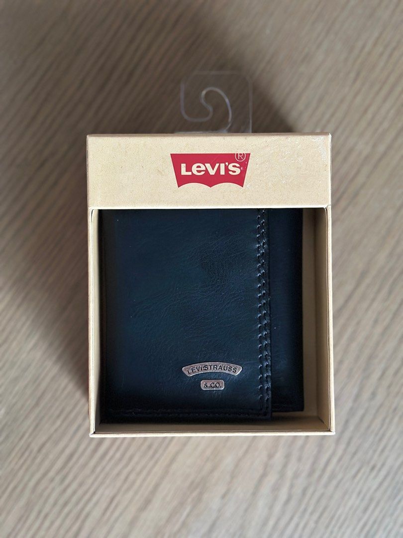 Levi's Black Trifold Wallet (Category: Wallets & Card Holders) located in Antipolo. Submitted by the_lawww (Listing ID 1466400457, Image 1). Description: - Brand: Levi's - Material: 100% Genuine Leather with contrast stitching - Color: Classic Black - Features: Metal logo plaque, multiple card slots, and spacious cash compartments - Condition: Brand new with original packaging boxes -With RFID protection ₱1,500 For meetups and delivery Antipolo, 