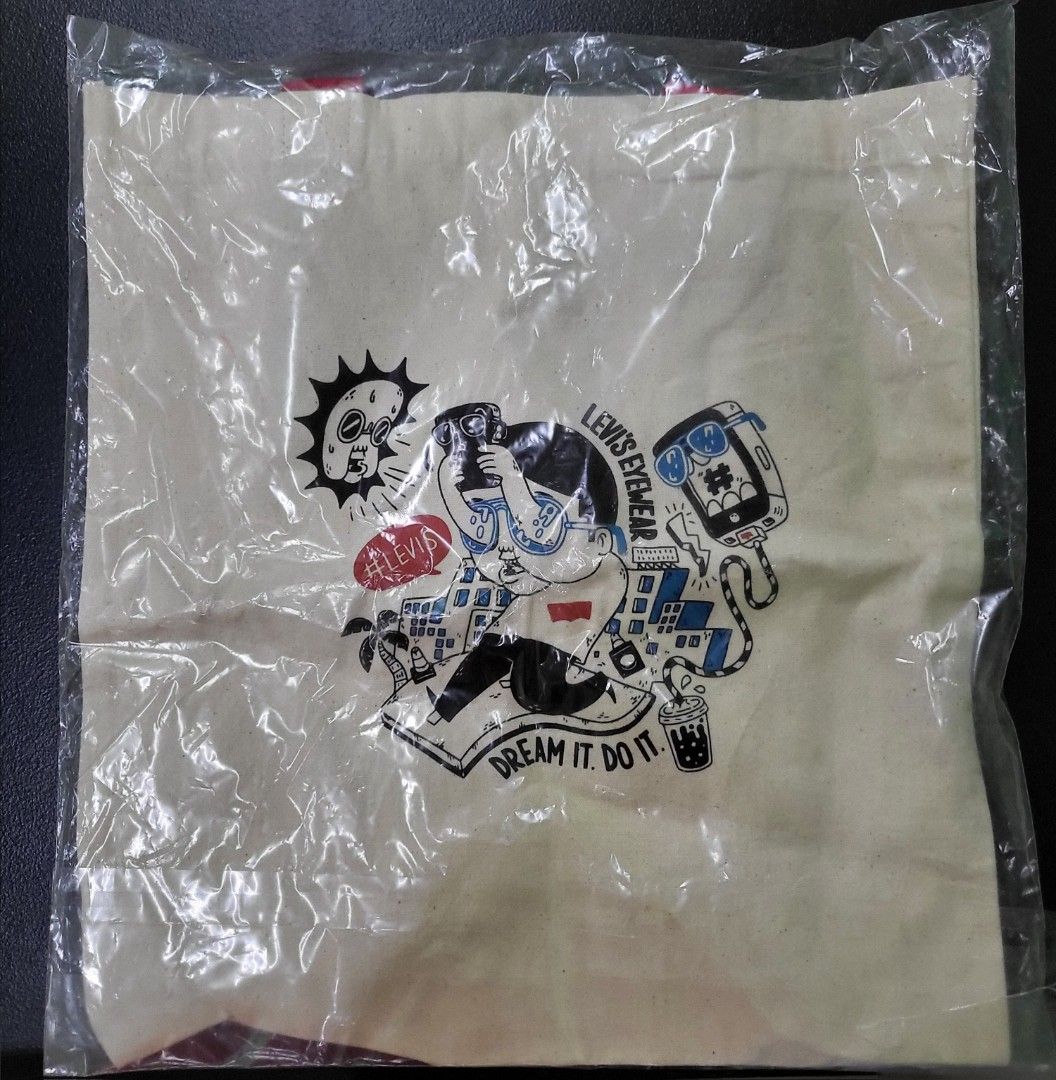 Levi's Eyewear Graphic Canvas Tote Bag (Category: Tote Bags) located in Manila. Submitted by marson_lagman (Listing ID 1466436136, Image 2). Description: - Brand: Levi's Eyewear - Color: Off-white canvas with red and blue shoulder handles - Design: Quirky comic-style print with 'Dream it. Do it.' text - Condition: Brand new, still sealed in original plastic packaging - Perfect for daily use, school, or casual outings.