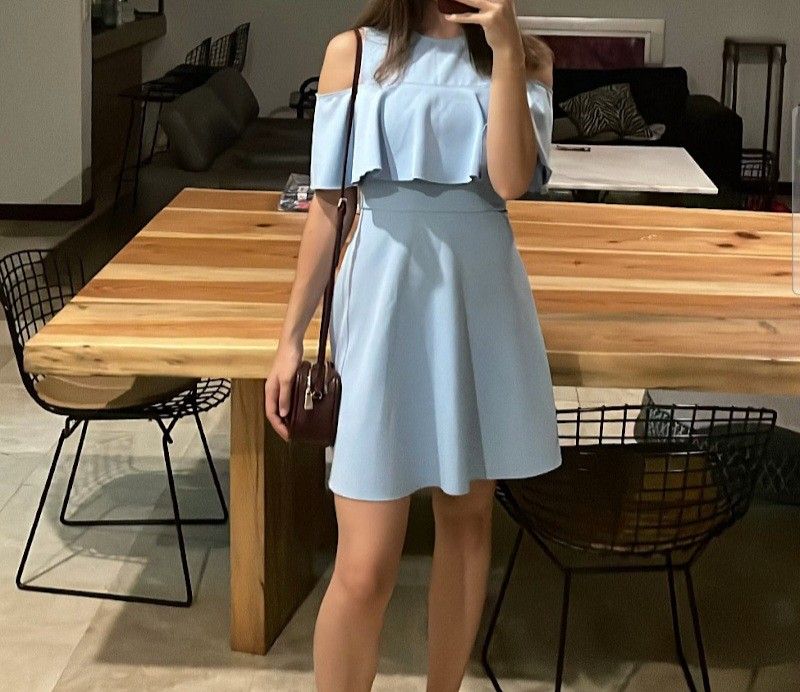 Light blue cold shoulder ruffle skater dress (Category: Dresses) located in Bacoor. Submitted by katecassan85266 (Listing ID 1466385149, Image 3). Description: Light blue skater dress with cold shoulder cutouts and ruffled overlay across the chest. Sheer mesh panel at the upper chest and neckline. Keyhole button closure at the back. Flared skater skirt silhouette. Short sleeves. Fun party or casual weekend outfit. Vibrant solid pastel color..