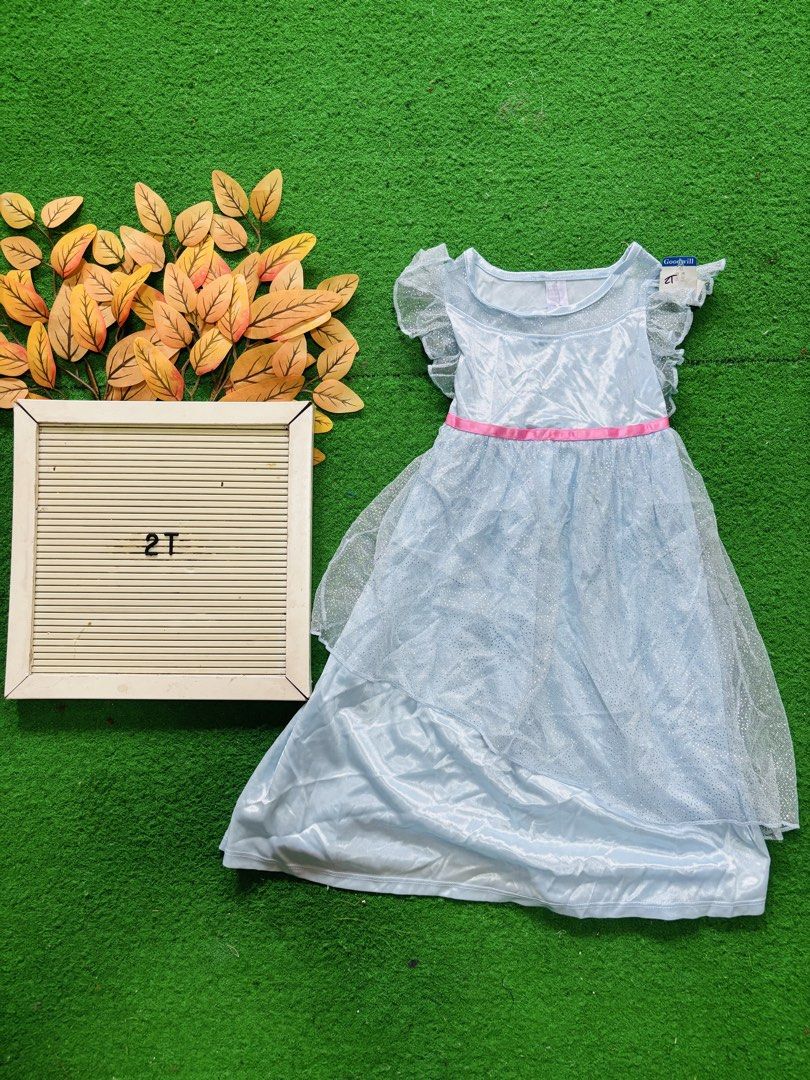 Light Blue Princess Dress Size 2T (Category: Babies & Kids Fashion) located in San Mateo. Submitted by ariakid47 (Listing ID 1466480896, Image 1). Description: - Size: 2T - Color: Light blue with pink waist ribbon - Features: Ruffle sleeves, sheer glittery skirt overlay, and soft shiny inner fabric - Design: Easy slip-on style - Perfect for: Parties, birthdays, and dress-up fun.