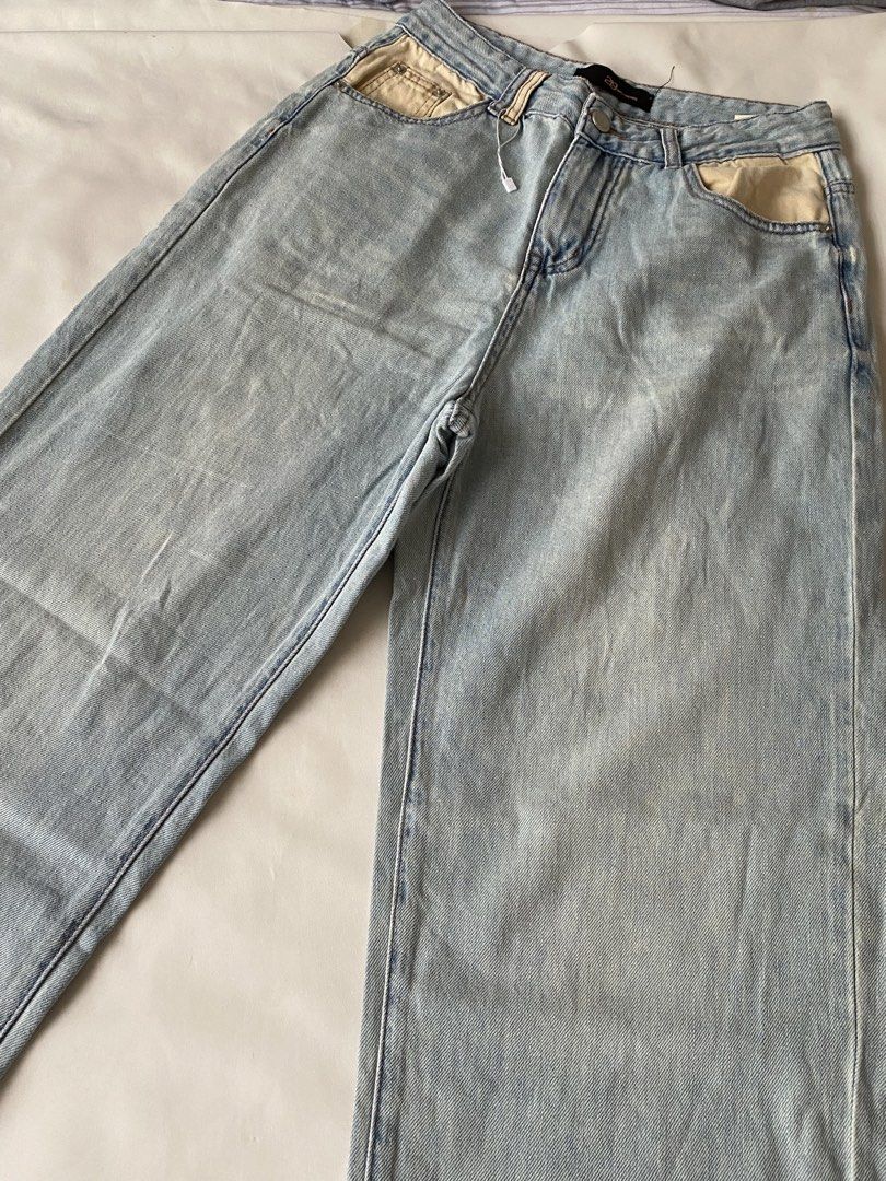 Light Blue Wide Leg Denim Jeans (Category: Jeans) located in Manila. Submitted by mpt99876 (Listing ID 1466522781, Image 2). Description: - Style: Light wash wide-leg denim jeans - Fit: Relaxed through the legs with slightly frayed hems - Details: Cream-colored contrast lining inside front pockets, classic zip fly and button closure, two back patch pockets - Versatility: Easy to style with casual tops and tees.