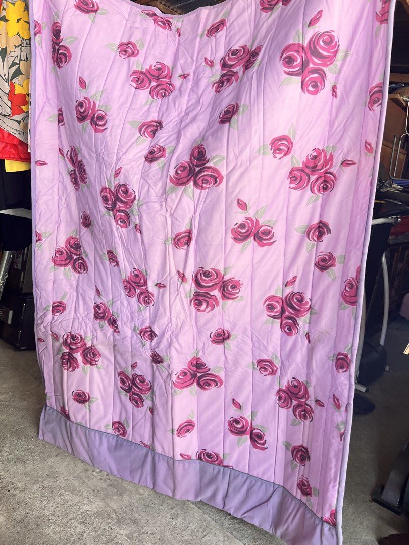 Light purple quilt with pink rose pattern (Category: Bedding & Towels) located in Manila. Submitted by suarezbaby04975 (Listing ID 1466473808, Image 1). Description: - Design: Light purple quilt with an all-over pink rose print and solid purple bottom border - Texture: Soft quilted feel with vertical stitching lines - Function: Adds extra warmth and a pop of color to any bedroom - Condition: Clean, fresh, and ready for daily use Single-semi doble