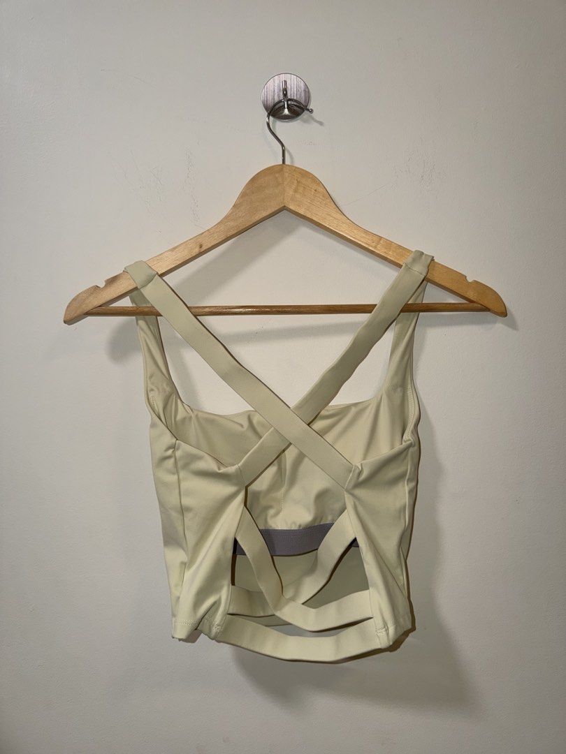 Light Yellow Activewear Crop Top with Strappy Back (Category: Activewear) located in Makati City. Submitted by andzr. (Listing ID 1466481071, Image 2). Description: - Color: Light yellow - Style: Activewear crop top - Neckline: Square front neckline with stylish crisscross straps on the open back - Support: Features a visible built-in bra band for extra support - Length: Cropped fit that sits right above the waist - Fabric: Soft, high-stretch mat