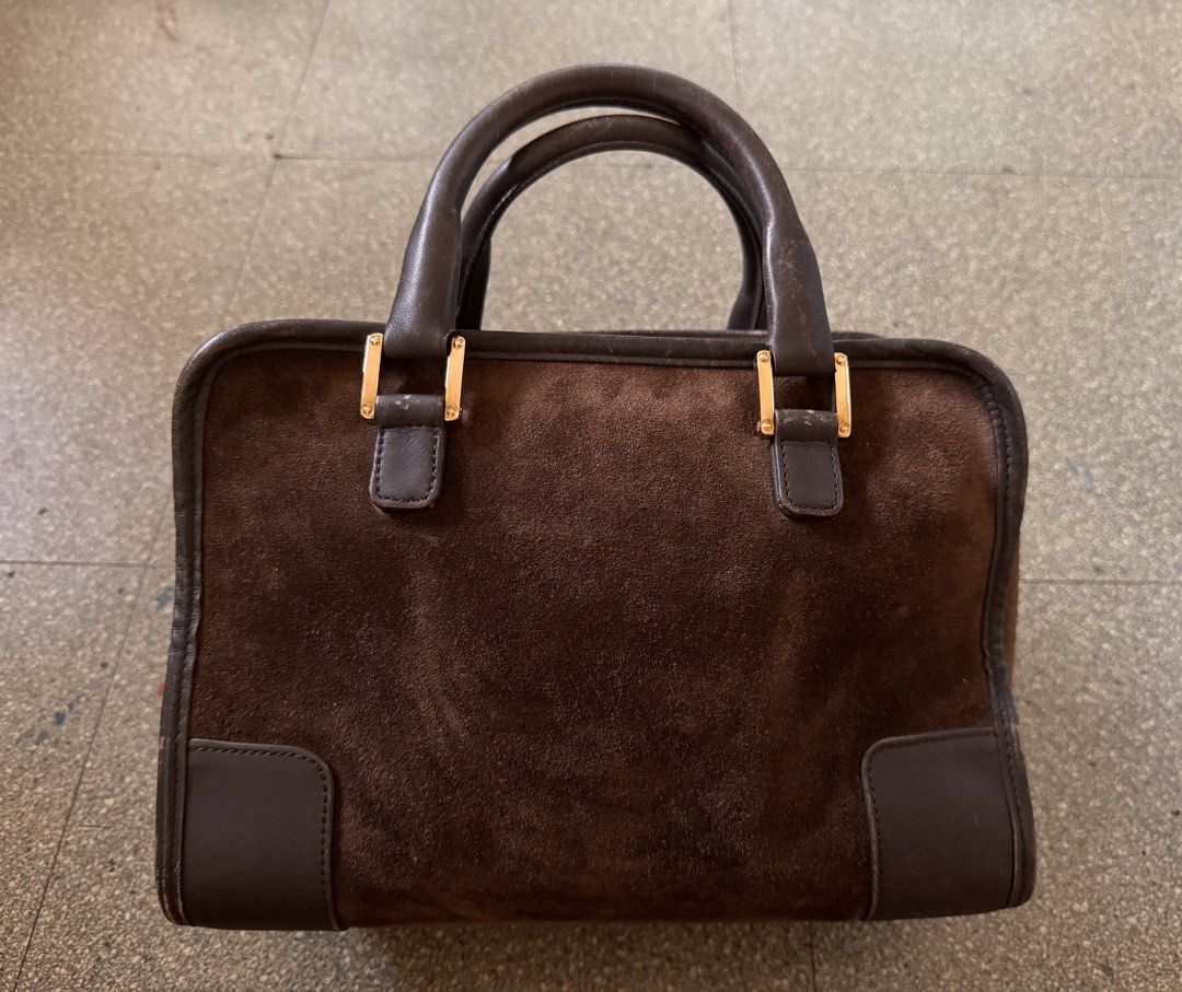 Loewe Brown Suede Amazona Handbag (Category: Luxury Bags & Wallets) located in Cavite. Submitted by aldrindela40142 (Listing ID 1466538642, Image 3). Description: Authentic Vintage brown suede Loewe handbag with dark brown leather trim and gold hardware. Classic embossed Anagram logo centered on the front. Dual rolled leather handles showing some wear from use. Zipper closure with engraved Loewe metal pull on the side. Structured boxy shape with 