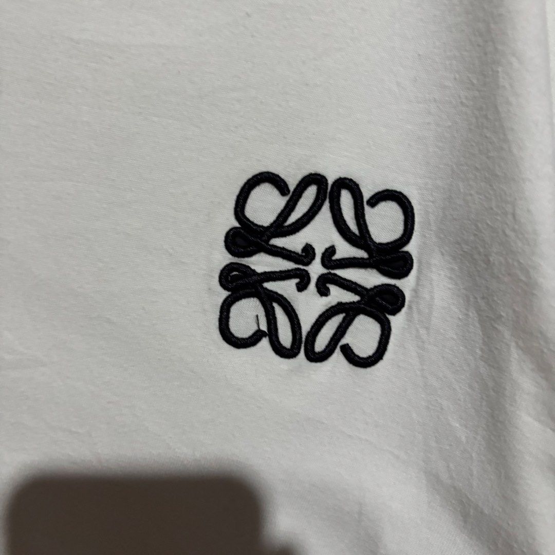 LOEWE EMBROID LOGO WHITE SHIRT (Category: Shirts) located in Taytay. Submitted by dwinsapparel (Listing ID 1466450477, Image 2). Description: LOEWE CHEST EMBROID LOGO WHITE SHIRT W-21 L-25 EXCELLENT CONDITION NEED WASH MISSING WASH TAGS.