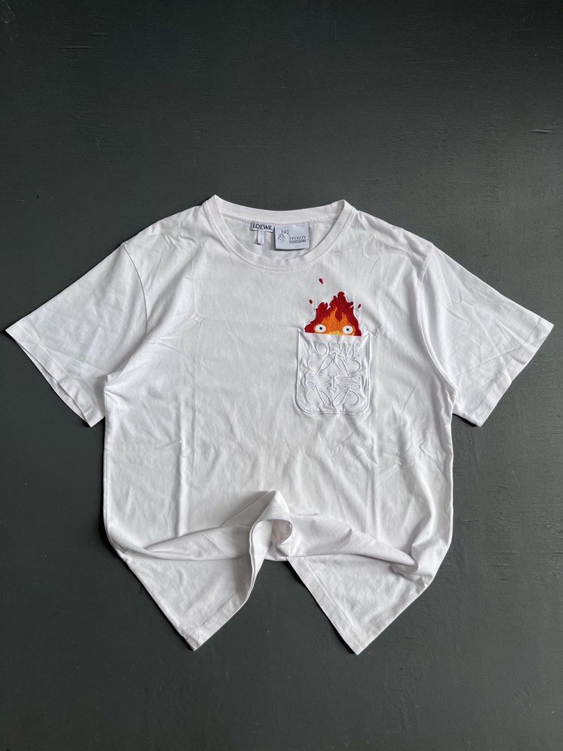 LOEWE X STUDIO GHIBLI 🔥 (Category: Tshirts & Polo Shirts ) located in Bacolod City. Submitted by johnkiercabungcal09 (Listing ID 1466391702, Image 1). Description: LOEWE x Studio Ghibli 🔥 Calcifer Peek-a-Boo Tee Size: S on tag (fits M) Dimes: 19.5” Width x 26” Length Condition: 9.5/10 - Excellent, no cracks / fade Detail: Full embroidery Calcifer, embroidered Anagram pocket Tags: Complete (Loewe + Ghibli Totoro tag + wash tag) Made in Portugal 