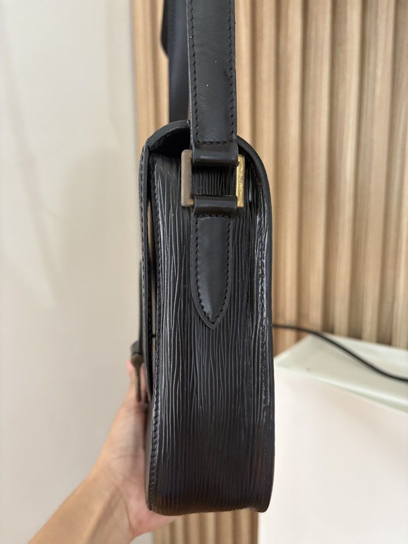 Louis Vuitton Black Epi Leather Shoulder Bag (Category: Luxury Bags & Wallets) located in Alicia. Submitted by berly06 (Listing ID 1466390361, Image 2). Description: - Brand: Louis Vuitton - Material: Textured Epi leather in deep black - Hardware: Brass with adjustable strap - Closure: Structured flap with branded metal ring drop - Details: Subtle LV initials embossed on the bottom corner - Style: Classic vintage daily carry crossbody bag.