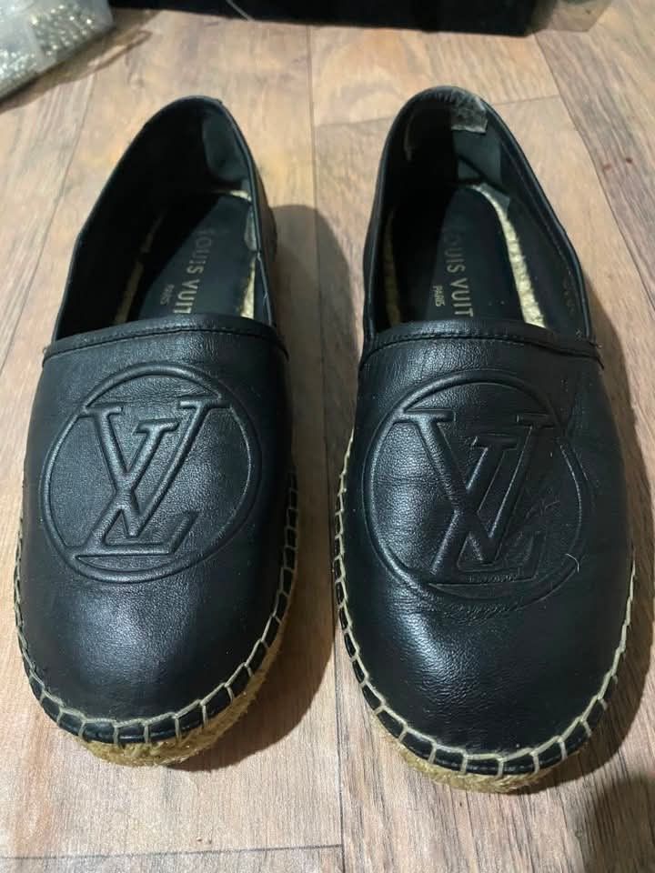 Louis Vuitton Black Leather Espadrilles Flat Shoes (Category: Sneakers & Footwear) located in Quezon City. Submitted by berde999 (Listing ID 1466395265, Image 1). Description: - Authentic Louis Vuitton slip-on espadrilles - Premium black leather upper with debossed LV monogram circle logo - Rounded toe design for comfortable wear - Traditional jute braided midsole trim with contrast stitching - Black insoles featuring the Louis Vuitton Paris stam