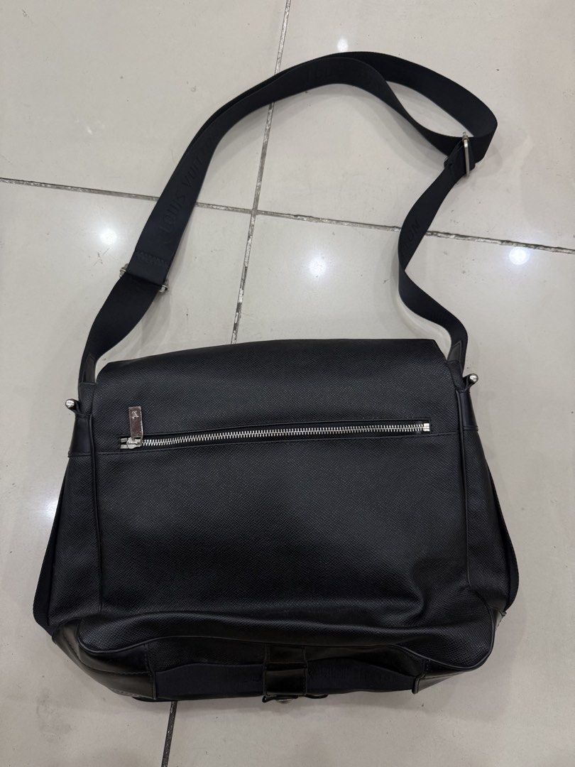 Louis Vuitton Black Messenger Bag (Category: Luxury Bags & Wallets) located in Bacolod City. Submitted by kitcarsonduff (Listing ID 1466476974, Image 2). Description: - Authentic black textured leather messenger bag - Adjustable fabric shoulder strap with Louis Vuitton lettering - Silver-tone metal hardware with secure front buckle closure - Convenient exterior back zip pocket for easy access - Subtle debossed LV initials on the lower corner and 