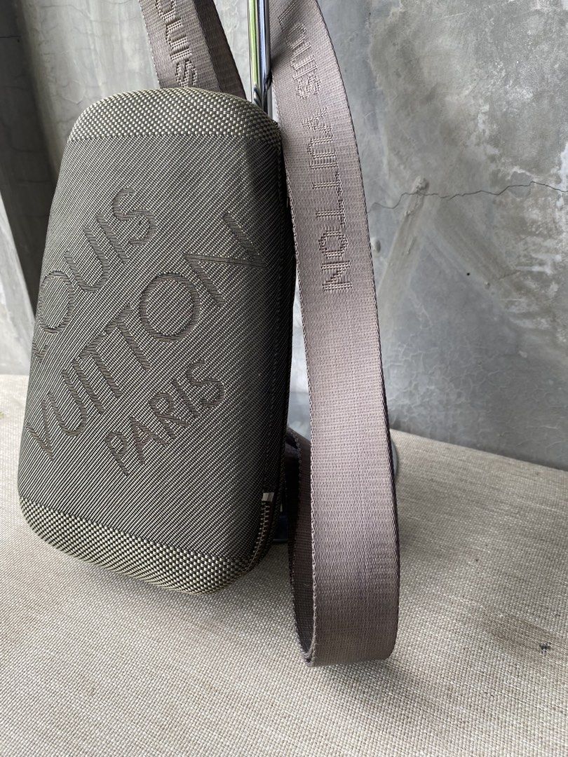 Louis Vuitton Damier Geant Crossbody bag (Category: Cross-body Bags) located in Manila. Submitted by why_notph (Listing ID 1466485701, Image 3). Description: - Brand: Louis Vuitton - Style: Compact vertical crossbody bag - Color / Material: Dark taupe textured fabric - Details: Debossed LV and Paris lettering on the front panel - Strap: Adjustable matching strap with woven LV branding and brown leather attachment loops - Closure: Secure wraparoun
