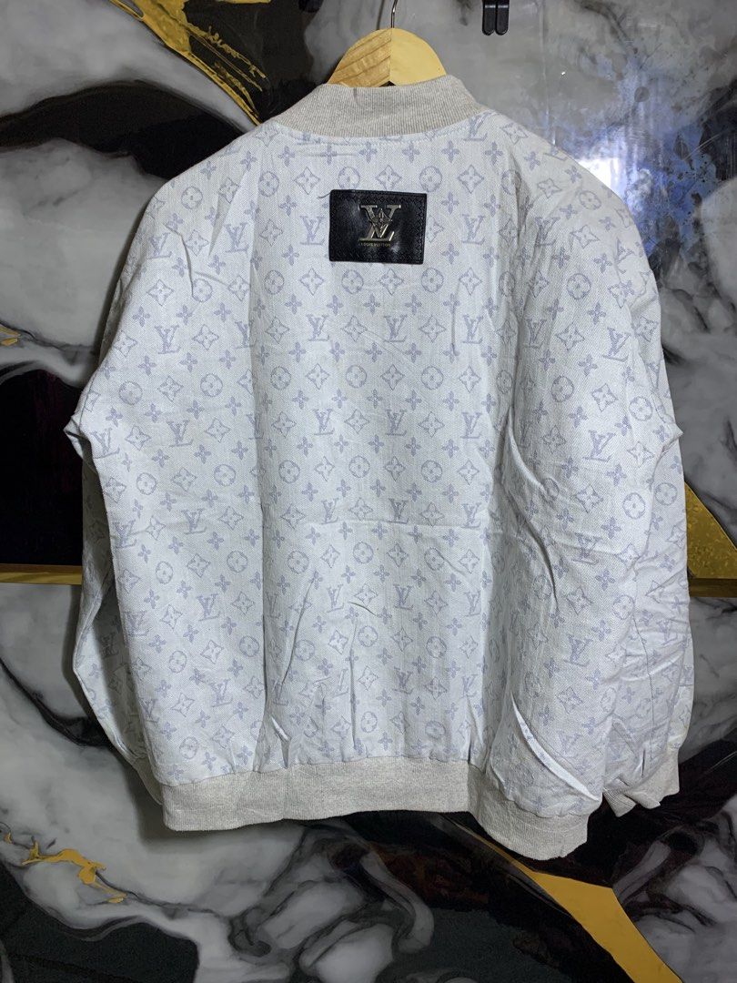 Louis Vuitton Monogram Denim Bomber Jacket (Category: Coats, Jackets and Outerwear) located in Davao. Submitted by youngboythrift25 (Listing ID 1466405961, Image 2). Description: Louis Vuitton zip-up bomber jacket. Light grey denim fabric covered all over in the classic LV monogram print. Ribbed knit collar, cuffs, and hem. Metal zipper closure down the front. Slip pockets on each side. Black leather brand patch with silver hardware on the back u