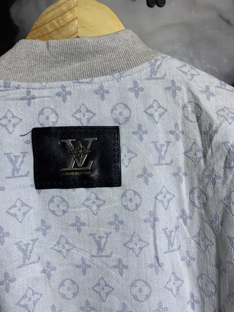 Louis Vuitton Monogram Denim Bomber Jacket (Category: Coats, Jackets and Outerwear) located in Davao. Submitted by youngboythrift25 (Listing ID 1466405961, Image 3). Description: Louis Vuitton zip-up bomber jacket. Light grey denim fabric covered all over in the classic LV monogram print. Ribbed knit collar, cuffs, and hem. Metal zipper closure down the front. Slip pockets on each side. Black leather brand patch with silver hardware on the back u